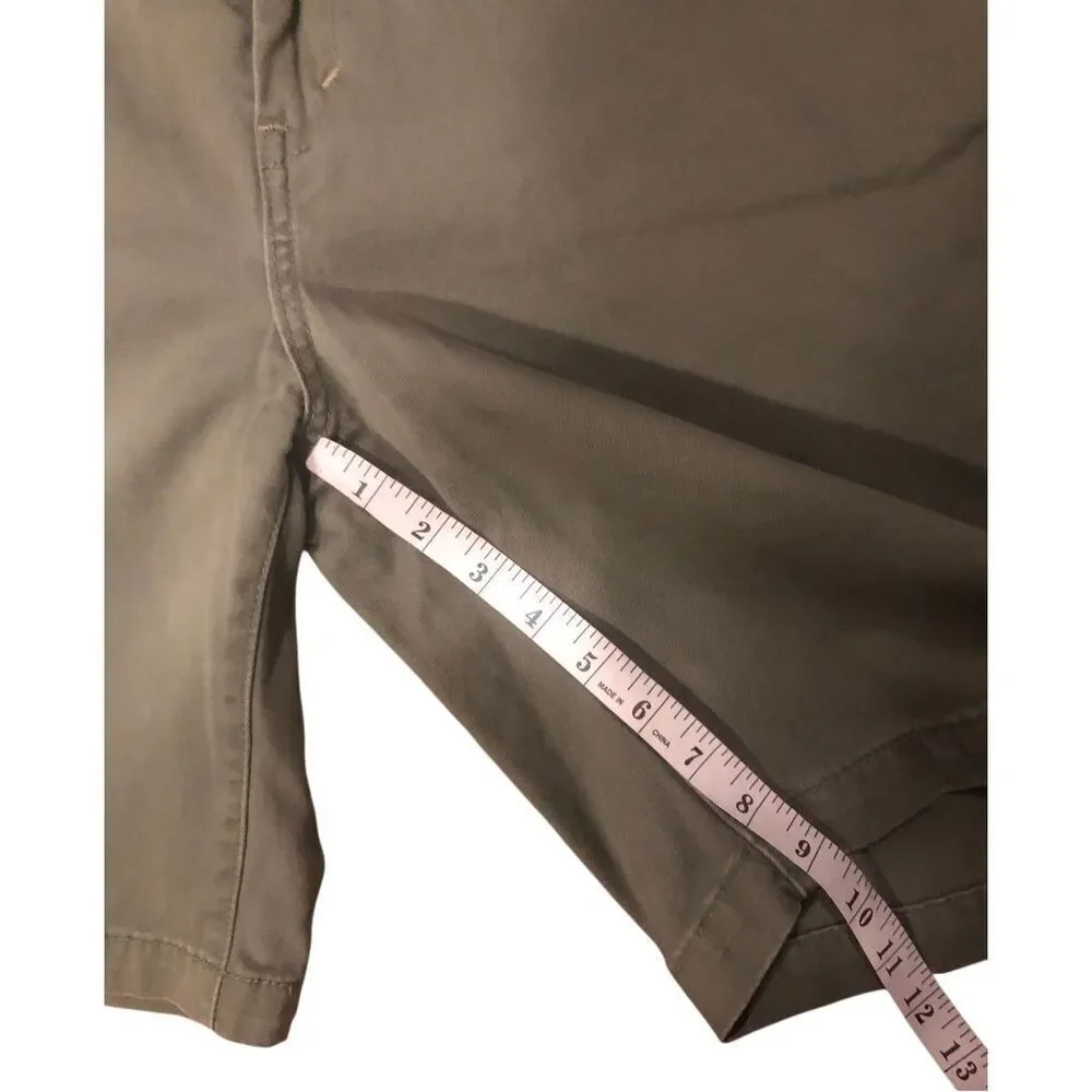 Levi’s olive green flat-front chino shorts. Button and zip fly closure, belt loo